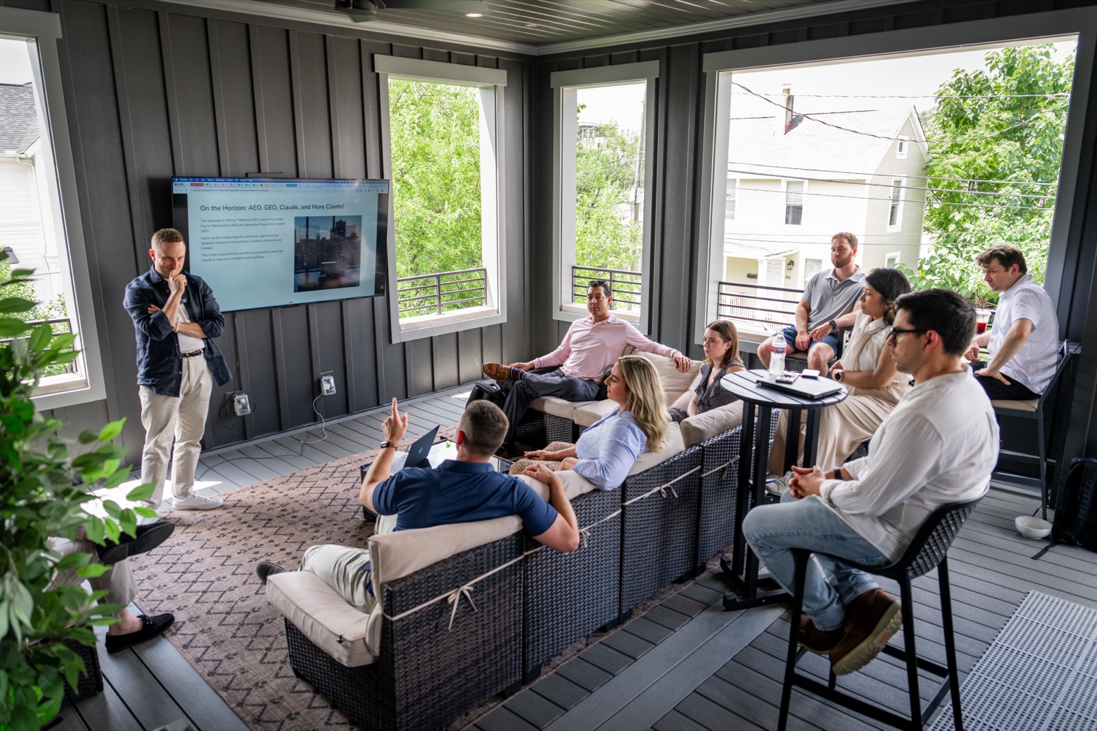 The Chek Creative team at an all-hands session on a covered porch