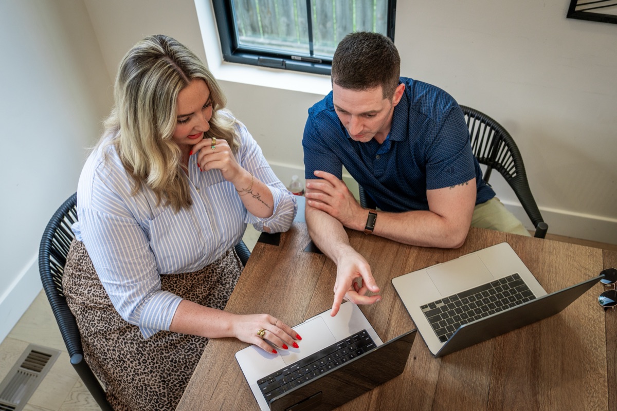 Two colleagues working together at a laptop